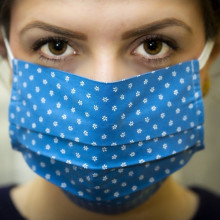 A woman wearing a facemask.