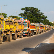 A line of trucks along a road in India.