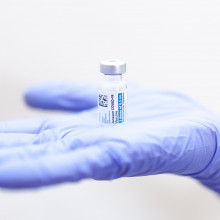 COVID vaccine in gloved hand
