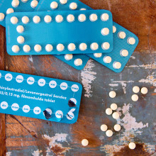 Image of contraceptive pills and packets on a wooden table