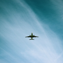 Plane flying through light clouds