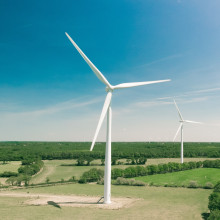 Two wind turbines in a countryside field