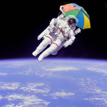 Astronaut Bruce McCandless II, mission specialist, participates in a extra-vehicular activity (EVA), a few meters away from the cabin of the shuttle Challenger. With an umbrella.