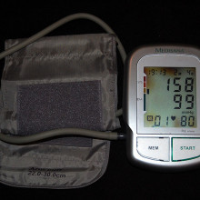 Automatic brachial sphygmomanometer showing grade 2 arterial hypertension (systolic blood pressure 158 mmHg, diastolic blood pressure 99 mmHg). Heart rate shown is 80 beats per minute.