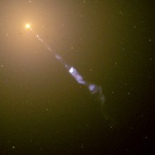  Streaming out from the center of the galaxy M87 like a cosmic searchlight is one of nature's most amazing phenomena, a black-hole-powered jet of electrons and other sub-atomic particles traveling at nearly the speed of light. In this Hubble telescope...
