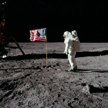 Astronaut Buzz Aldrin poses for a photograph beside the United States flag