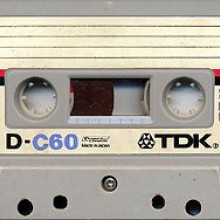 A TDK D-60 cassette, a common speech-quality tape with a 60-minute playing time, in a housing similar to that of the original Compact Cassette specification