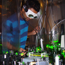 Dr Dhiren Kara adjusting the laser system used to measure the shape of the electron.